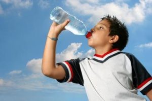 boy drinking from water bottle