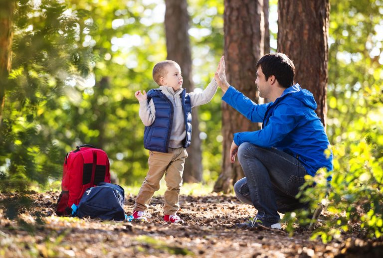 Father and son enjoying a walk in the forest