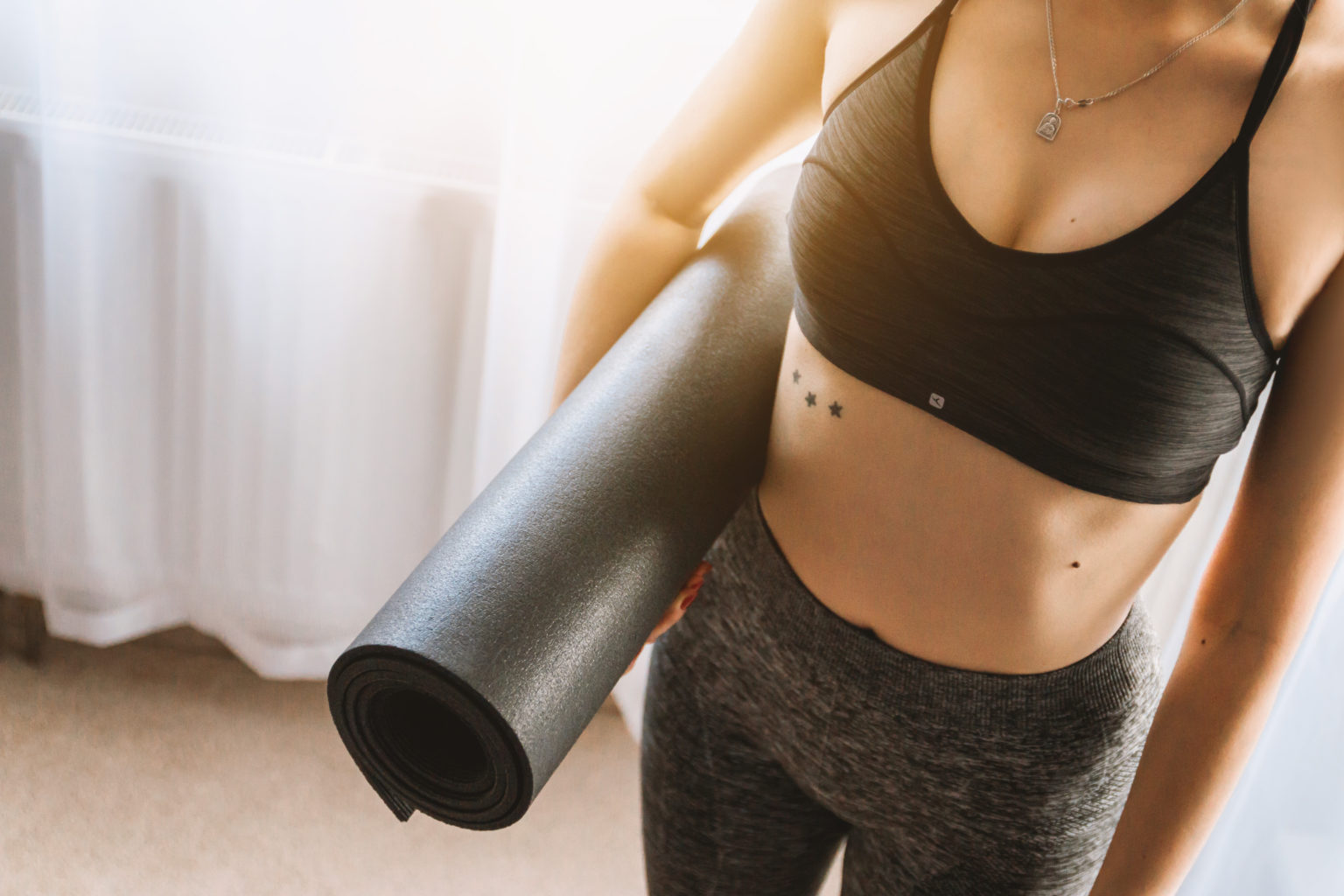 Canva - Woman in Black Sports Bra With Grey Leggings Carrying Yoga Mat